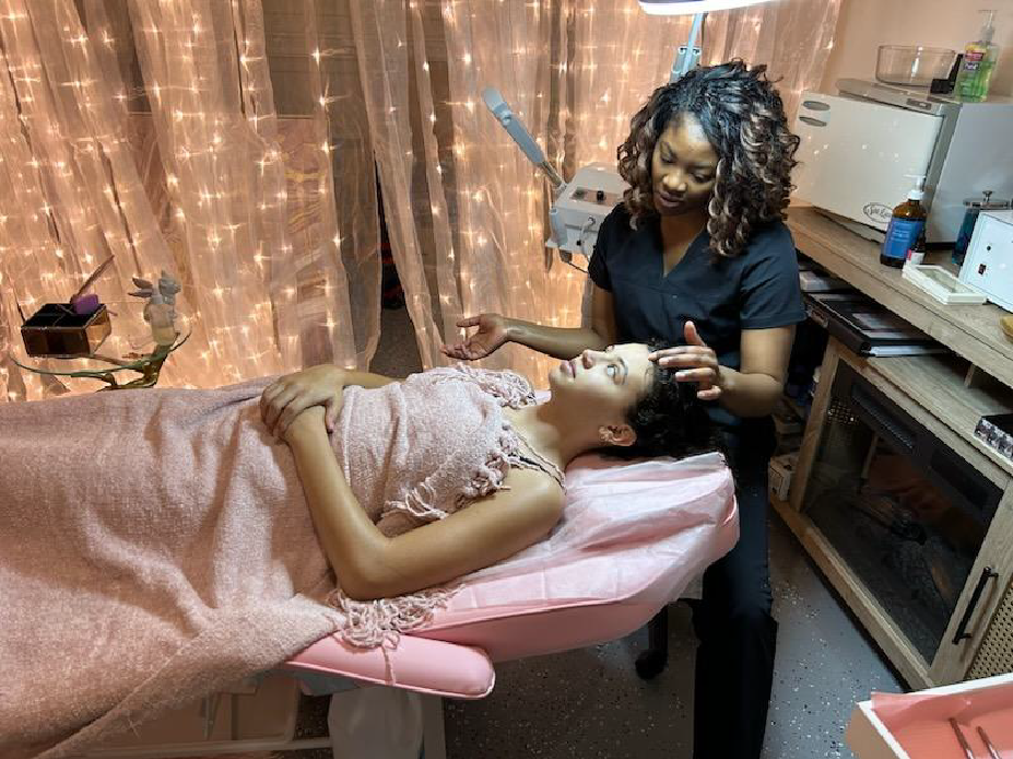 Large photo of a client receiving hair removal services by esthetician and owner Nahaila Osborne